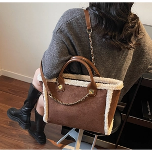 Brown faux suede tote bag with creamy white sherpa trim and stylish metal chain