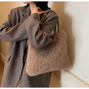 Detail of tan plush tote bag with long faux fur texture and woven shoulder strap
