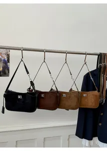 Detail view of retro suede shoulder bags in four colors with silver metal twist locks