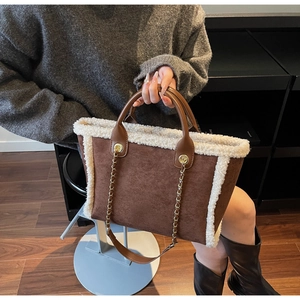 Brown suede tote bag with white faux shearling trim and gold chain leather strap details