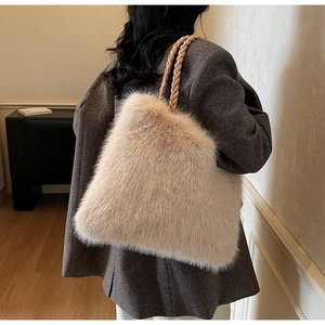 Detail of soft plush tote bag featuring durable khaki woven handles and large capacity