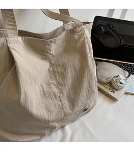 Detail view of khaki large tote bag featuring lightweight soft micro-crinkle texture fabric