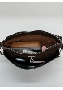 Top view of spacious interior of brown leather shoulder bag with multiple compartments