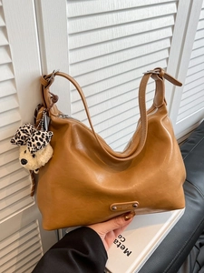 Vintage brown shoulder tote bag with adjustable strap and cute plush bear keychain