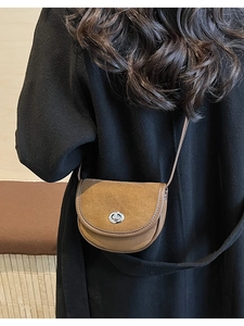 Brown frosted saddle bag shown on a black coat back view for a retro commute look