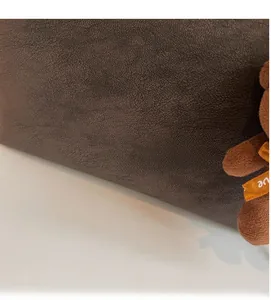 Gros plan du sac cabas en cuir marron foncé au grain vintage avec logo doré