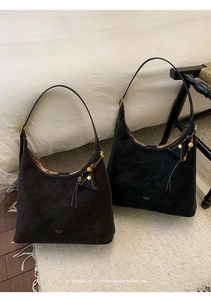 Close-up of matte vintage hobo bags with golden hardware, beads and long fringe details
