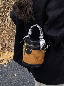 Vintage cylinder bucket bag in brown suede with quilted patterns and silk scarf handle