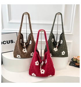 Close-up of knit tote bags with floral embroidery and wooden horn buckle closure