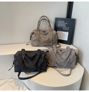 Detailed display of three vintage large capacity Boston bags with adjustable shoulder straps