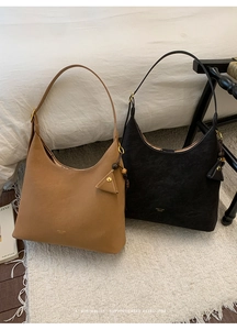 Close-up of retro matte hobo bags with gold buckle details and textured leather
