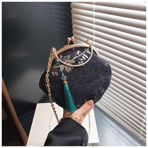 Detail of Chinese style embroidered shell bag with gold chain and silk tassel