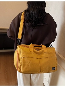 Bright yellow large capacity nylon travel duffel bag with shoulder strap and multiple pockets