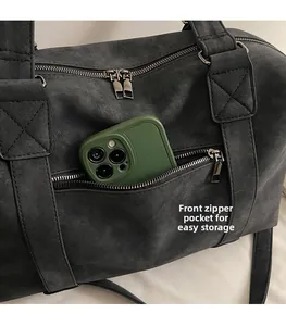 Detail showing the front zipper pocket for smartphone storage on gray tote bag