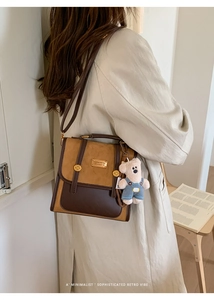 Detail of vintage patchwork crossbody bag featuring brown leather and a plush bear charm