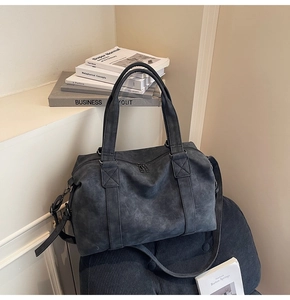 Detail view of large dark grey retro tote bag with smooth zippers and textures
