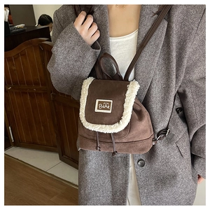 Detail of vintage plush teddy backpack with bear patch and suede texture on back