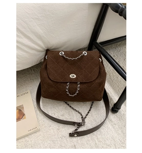 Quilted velvet bucket bag in dark brown with metal chain strap and turn-lock detail