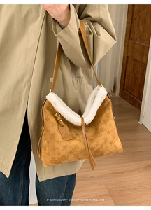 Close-up of retro brown suede bag with white faux fur trim and vintage embossed patterns