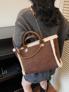 Women's brown suede tote bag with white faux fur trim and gold chain shoulder strap