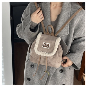 Detail of khaki suede mini backpack with white fleece trim and Bear leather patch