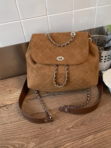 Elegant brown suede quilted backpack with chain straps and classic flap closure
