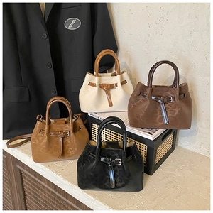 Detailed close-up of four retro bucket bags in cream, brown, tan, and black textures