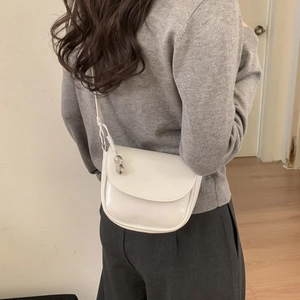 Detailed back view of a white saddle bag showing size and proportion on a model