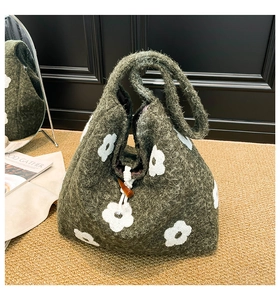 Detailed close-up of plush floral tote bag with wooden toggle button and white embroidery