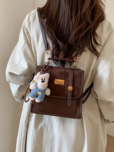 Retro brown contrast texture backpack with a teddy bear charm and gold metal logo