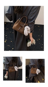 Detail view of brown leopard print bucket bag with metal buckle and plush rabbit charm