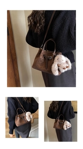 Detail of dark brown retro tote bag with buckle design and cute rabbit plush charm
