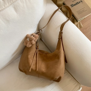 Brown frosted leather hobo bag with zip closure and detachable plush bear pendant