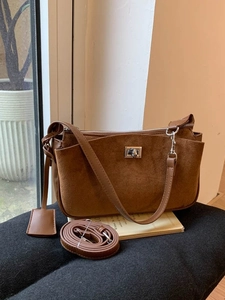 Retro brown suede underarm bag with silver twist lock and adjustable shoulder strap