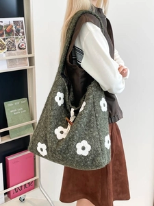 Forest green plush tote bag with white flower embroidery and vintage toggle closure