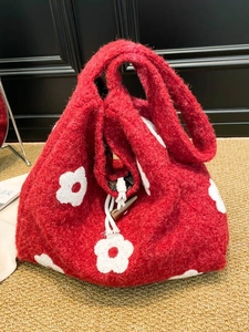 Red plush tote bag with white flower embroidery and wooden toggle button closure