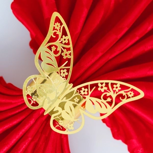 Elegant gold hollow butterfly napkin ring with floral cutouts for wedding table decor