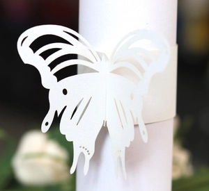 Macro view of laser-cut white butterfly paper napkin ring for elegant table decoration