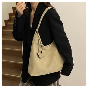 Gros plan sur le grand sac cabas minimaliste en cuir blanc cassé avec bandoulière large