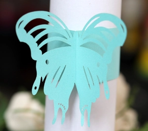 Teal laser-cut butterfly paper napkin ring with intricate hollow texture for party decor