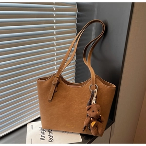 Détails d'un cabas en cuir PU marron avec bandoulières réglables et pendentif ours