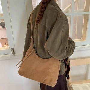 Detail of camel suede tote bag showing large capacity and adjustable shoulder strap