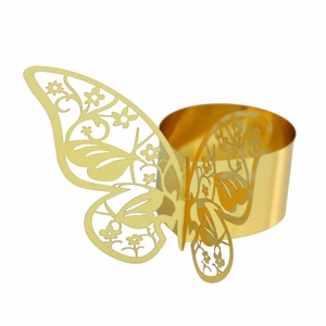 Detailed view of golden butterfly napkin ring with intricate laser-cut floral patterns