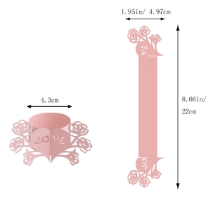 Macro view of pink laser-cut paper napkin rings with LOVE lettering and rose details