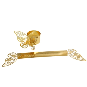 Macro detail of laser-cut gold butterfly napkin ring with floral hollow patterns
