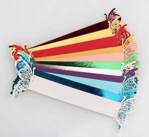 Macro detail of laser-cut butterfly napkin rings in various pearlescent metallic colors