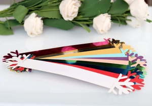 Macro view of multi-color Christmas snowflake napkin rings with metallic paper texture