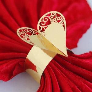 Golden heart napkin ring with laser-cut hollow pattern for wedding table decor