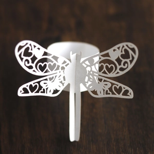 Detailed laser-cut dragonfly napkin ring made of white pearlescent paper for parties