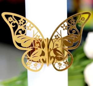 Macro view of the laser-cut pink butterfly napkin ring with intricate floral pattern